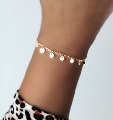 Gold-plated silver mini-chain bracelet, for a modern and elegant look, with 8 mini charms in the form of discs or small plates.  This bracelet will bring a subtle movement to your wrist thanks to its 8 dangling plates. Each round and flat badge measures 4 mm in diameter.  The total length of the bracelet is 16 cm and it has an additional 3 cm as an extension, so that you can adjust it to the perfect size of your wrist.  Ideal both to wear it alone and to combine with other bracelets in your jewelry box. --------------------- COMBINE: Buy more items no extra charge for each order, you just pay one shipping fee no matter how many items you purchase. --------------------- SHIPPING METHOD: It will take approx 1 week to US & Canada, and 3-4 days to Europe.   All orders would be shipped within 1 Dainty Metal Bangle Charm Bracelet, Adjustable Gold Sterling Silver Bracelet, Party Charm Bracelet With Dangle, Trendy Simple Bracelet Jewelry, Trendy Simple Metal Jewelry, Trendy Simple Bracelet, Trendy Simple Design Bracelet, Minimalist Charm Bracelet For Parties, Dainty Metal Charm Bracelet For Party