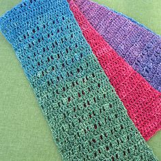 three crocheted scarves sitting on top of each other