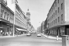 an old black and white photo of a city street