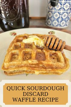 a close up of a waffle on a plate with butter and syrup in the background