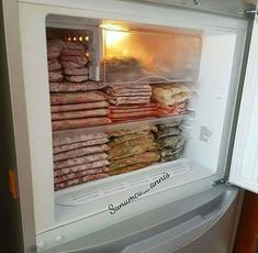 an open refrigerator filled with lots of different types of food and meats in it