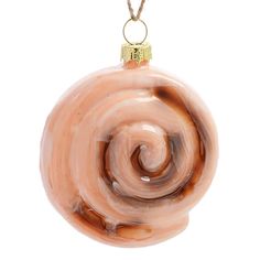 a glass ornament with a spiral design hanging from a cord on a white background