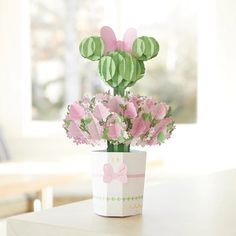 a paper flower pot with pink flowers in it