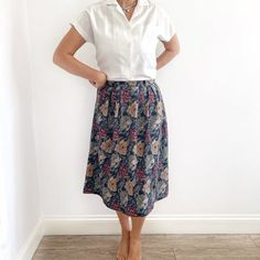 Beautiful dark floral skirt with pleats, buttons at the back (or front), belt loops and length that falls below the knee. Made from light smooth material, fully lined underneath.No labels or tags.Size labelled 38, measurements when laid flat are:Waist: 37cmHips: 55cmLength: 72cmExcellent condition. Workwear Floral Print Knee-length Skirt, Floral Print Knee-length Skirt For Work, Knee-length Floral Print Skirt For Work, Floral Print Flared Skirt For Workwear, Casual Floral Print Midi Pleated Skirt, Casual Floral Print Pleated Midi Skirt, Casual Long Floral Print Pleated Skirt, Daywear Floral Print Flared Skirt, Casual Long Pleated Floral Skirt