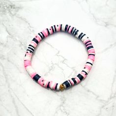 Color: Pink, Black and White Size: 6.5 inches This stretch bracelet is made with 6mm polymer clay and vinyl heishi disk beads.  A variety of pink, black, and white beads have been randomly selected to create this unique random pattern. The beads are strung on a stretchy cord. There is a small gold-colored spacer bead. This bracelet measures approximately 6.5 inches and fits a medium-sized wrist. The beads are 6mm. ★Do not wear jewelry while swimming or bathing/showering. ★Keep jewelry in a dry l Cheap Pink Polymer Clay Bracelets, Random Pattern, Black Clay, Bead Pattern, Pattern Ideas, Keep Jewelry, White Beads