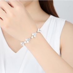 Gorgeous natural real pearl floral leaf diamond crystal wedding bridal bridesmaids bracelet, super sparkly and stunning. Handmade of top quality natural ivory pearls, AAA diamond CZ, and 925 sterling silver. 17cm length, 1.5 cm width, with exquisite buckle closure. Delicate elegant bracelet looks perfect as wedding bridal bridesmaid jewelry, or just as everyday high end accessories. Beautiful shimmery last for years, best quality guaranteed. 💎 Features: ♥ Material: Real gold plated 925 sterling silver ♥ Main stone: Top quality natural freshwater ivory pearls ♥ Side Stone: Cz crystal 💎 Details: ♥ Approximate Measurements: - Length: 17 cm - Width: 1.5 cm ♥ Lightweight, easy to wear ♥ Nickel/Lead Free, Hypoallergenic, good for sensitive skins 🎁 Packing & Shipping: ♥ All our jewelry will be White Diamond Pearl Bracelet For Anniversary, White Pearl Diamond Bracelet For Anniversary, Pearl Bracelet With Pearl Drop, Pearl Drop Bracelet Jewelry, Elegant Crystal Chain Bracelet For Gift, Elegant White Gold Pearl Bracelet With Diamonds, Elegant Cubic Zirconia Crystal Bangle Bracelet, Elegant Diamond White Cubic Zirconia Crystal Bracelet, Formal Pearl Embellished Bracelet Jewelry