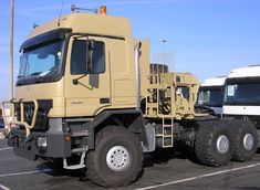 a large yellow truck parked in a parking lot