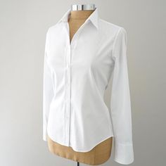 Expertly crafted in Italy for Shirtini. Luxurious Egyptian cotton with a bit of stretch so you can work, play, or party. May be worn out, tied, or tucked. Crisp collar to pop or fold neatly down. Long sleeves to style as you please. Single button cuffs. Mother of pearl buttons. 70% cotton, 27% nylon, and 3% elastane. F The Perfect White Shirt, Fitted White Shirt, Perfect White Shirt, Shirt Dresses, Egyptian Cotton, White Shirts, Mother Of Pearl Buttons, White Shirt, Button Up