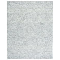 a white rug with an intricate design on the front and back side, in shades of blue