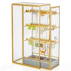 a gold jewelry display case filled with lots of necklaces and earring hooks in it