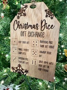 a wooden christmas ornament hanging on a tree with the words, christmas dice gift exchange