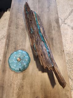 a piece of driftwood next to a blue glass object