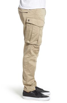 Stretch-cotton pants in a tapered profile rock a modern, utilitarian look with cargo-style pockets and ergonomic seaming for a more active fit. 32" inseam; 14" leg opening; 10" front rise; 15" back rise (size 32) Zip fly with button closure Side slant pockets; back flap pockets; side cargo pockets 97% cotton, 3% elastane Machine wash, dry flat Imported Functional Cargo Pants With Multiple Pockets For Work, Functional Cargo Pants With Cargo Pockets For Work, Functional Straight Leg Cargo Pants, Utility Cargo Pants With Tapered Leg, Techwear Cargo Pants With Multiple Pockets, Functional Cotton Cargo Jeans With Hip Pockets, Cotton Cargo Jeans With Cargo Pockets, Functional Cotton Cargo Jeans With Pockets, Utility Cargo Pants With Functional Pockets For Work