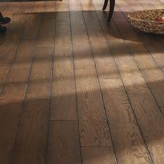 a living room filled with furniture and a wooden floor covered in lots of wood planks