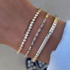 Bezel Set Bridal Bracelet, Diamond Tennis Bracelet, Bar Setting Baguette And Round Cut Moissanite Bracelet, Engagement Bracelet In 18k Gold    ✹✹𝐖𝐞𝐥𝐜𝐨𝐦𝐞 𝐭𝐨 𝑻𝒉𝒆𝑩𝒂𝒏𝒅𝒔𝑺𝒉𝒐𝒑✹✹ ★ 𝑺𝒕𝒐𝒏𝒆𝒔 𝑫𝒆𝒕𝒂𝒊𝒍𝒔 ★ ● Stone Type:- Simulated Diamond, Moissanite ● Color:- DEF ● Clarity: VVS-VS ● Cut Grade: Excellent ● Making Process: Handmade - Crafted by our experienced team ⇨ 1st Bracelet:- ✎ Stone Shape: Round Cut ✎ Stone Size: 3.00 mm  ⇨ 2nd Bracelet:- ✎ Stone Shape: Baguette Cut ✎ Stone Size: 5x2.50 mm ⇨ 3rd Bracelet:- ✎ Stone Shape: Round Cut ✎ Stone Size: 4.00 mm ★ 𝑰𝒕𝒆𝒎 𝑫𝒆𝒕𝒂𝒊𝒍𝒔:- ☛ Metal Purity: Solid Gold (10KT, 14KT, 18KT); Silver(925 Sterling, 935 Argentium), 950 Platinum ☛ Metal Tone: Yellow, White, Rose ☛ Stamp/Hallmark: Yes ★ 𝑪𝒖𝒔𝒕𝒐𝒎𝒊𝒛𝒂𝒕𝒊𝒐𝒏:- ☛ Cus Moissanite Bracelet, Sunlight Photography, Baguette Bracelet, Bracelet Bar, Bar Setting, Bracelet Stone, Bracelet Diamond, Diamond Tennis Bracelet, Wedding Jewelry Bracelets