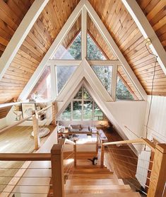 a loft with wooden floors and white walls