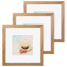 three wooden frames with an image of two oranges and a hat on the table