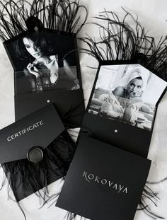 three black and white photographs are laying next to each other on the floor with feathers around them