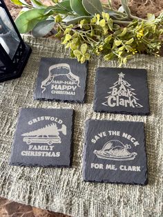 four slate coasters sitting on top of a table