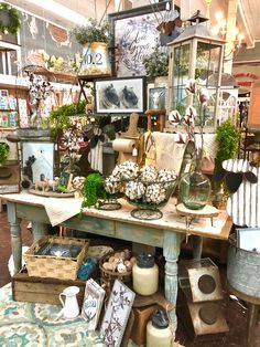 a room filled with lots of different types of furniture and decor on top of a wooden table