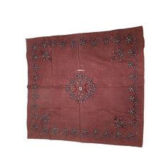 a red cloth with an intricate design on it