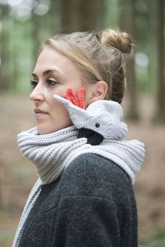 a woman wearing a scarf with an elephant on it's head in the woods