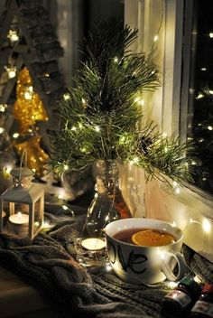 a cup of tea sitting on top of a table next to a window sill