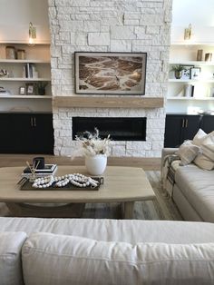 a living room filled with furniture and a fire place