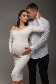 a pregnant couple posing for a photo