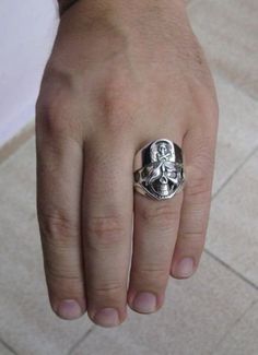 Sterling silver biker ring 925/1000, skull. Stamped 925. Approximate weight 15.8 grams. Width 2.5cm All our jewels are made from solid sterling silver 925/1000 and are carefully crafted by hand in our family workshop. We dispatch your orders in 5 working days, worldwide and the postage is $5. We ship registered priority mail. Please allow 5-7 working days for delivery in Europe and 10-15 working days outside Europe. For any questions - please do not hesitate to contact me! Skull Shaped Sterling Silver Ring In White Gold, Collectible Sterling Silver Skull Ring With Polished Finish, White Gold Round Skull Ring Stamped 925, Silver Engraved Skull Ring, Silver Symbolic Skull Ring Hallmarked, Sterling Silver Skull Ring Hallmarked, Silver Skull Rings Hallmarked, Silver Skull-shaped Engraved Rings, Silver Skull Ring With Hallmark