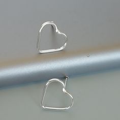 ONE PAIR of sterling silver heart ear studs. Dimensions: 10 x 9 Weight: 0.52 gm These earrings are made of 925 hypoallergenic sterling silver. Please note this price is for ONE PAIR only. All my pieces are sent in a gift box. I can include a personal message from you if needed You are welcome to contact me at... bhavnakwintra1956@gmail.com For more beautiful pieces from my shop, please browse 👇 TOE RINGS: https://www.etsy.com/your/shops/TheSilverGame/tools/listings/section:27020628,view:table E Modern Sterling Silver Heart Earrings For Gift, Modern Silver Heart Earrings For Gifts, Silver Open Heart Minimalist Earrings, Silver Minimalist Open Heart Earrings, Silver Minimalist Earrings For Valentine's Day, Earrings Minimalist, Silver Accessories, 925 Silver Jewelry, Feather Earrings