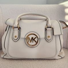 *Brand New & Never Worn* - Original Tags W/ Dustbag Included. White Michael Kors Satchel Bag In The Color "Vanilla". Leather Material With Gold Hardware. Very Spacious With Multiple Pockets And Compartments And A Long Strap To Be Worn As A Cross Body. Dimensions: L - 12" H - 8" W - 6.5" Michael Kors Cream Shoulder Bag With Detachable Handle, Michael Kors Cream Bag With Detachable Handle, Cream Michael Kors Crossbody Shoulder Bag, Michael Kors Beige Satchel With Detachable Handle, Michael Kors Cream Crossbody Shoulder Bag, Cream Shoulder Bag With Branded Hardware And Double Handle, Cream Shoulder Bag With Branded Hardware, Michael Kors Beige Shoulder Bag With Detachable Handle, Michael Kors Cream Top Handle Shoulder Bag