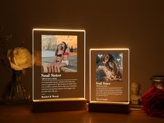 two illuminated photos are shown on a table next to a vase with flowers in it