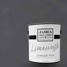 a white paint can with the words limewash painted on it, against a gray background