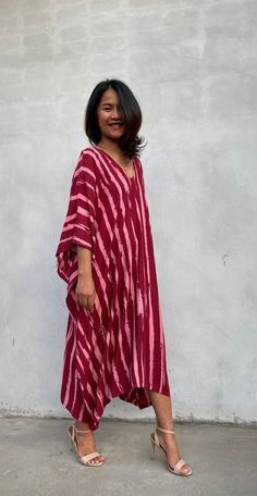 Indulge in the beauty of our classic kaftan with hand silk-screen printed fabric. This kaftan dress boasts unique patterns on high-quality rayon fabric. Its versatile design allows you to create many stylish looks, ensuring you always feel your best, whether you're at home or stepping out. Red Bohemian Kaftan With Ikat Print, Flowy Red Printed Kaftan, Red Flowy Kaftan With Kimono Sleeves, Red Oversized Bohemian Kaftan, Flowy Red Maxi Kaftan, Red Kimono Sleeve Beach Dress, Red Beachwear Dress With Kimono Sleeves, Oversized Red Bohemian Dress, Red Batik Print Kaftan For Summer