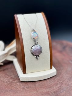 Soft mauve colors with creamy veining give this Agua Nueva Agate a delicate look. Set on a sterling silver landing and wrapped with silver beaded wire. Silver balls at the bottom of this pendant give this piece a little something extra. Ethiopian Welo Opal has all the flash and iridescent colors. Handmade and one of a kind. This piece comes with a sterling silver chain. Please send message/email with length request (16, 18, 20 or 22 inches). Pendant Measurements Length 2.5 in Width 1 in Elegant Silver Jewelry With Pink Opal, Elegant Silver Pink Opal Necklaces, Elegant Silver Pink Opal Necklace, Elegant Silver Pink Opal Jewelry, Handmade Elegant Pink Opal Jewelry, Elegant Handmade Pink Opal Jewelry, Silver Opal Wire Wrapped Necklace, Elegant Pink Opal Jewelry With Natural Stones, Artisan Silver Opal Necklace