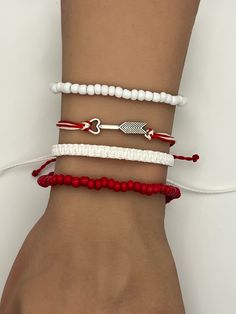 Cupid Arrow Bow Charm Friendship Bracelet. Pura Vida style string, braided, woven, beaded, adjustable bracelet.  Fits most wrists and are stackable.  Perfect for everyday casual wear, activities, and special events. Can be worn individually or as a set. SIZING: White Braided Bracelet:  6 - 11 inches Beaded Red/White Bracelet:  2.36 inches CARE: Bracelets are durable, but excess pulling or yanking may cause them to break. SPECIAL NOTES: Your new bracelet may be slightly sticky/tacky for a few days.  This will not last, but may make adjusting slightly difficult for a bit. Arrow Bow, Cupid Arrow, Wax Cord Bracelet, Knotted Bracelet, Bracelets Adjustable, Thread Bracelet, Arrow Bracelet, Cupids Arrow, Bow Bracelet