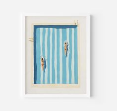 two people are swimming in a pool with blue and white striped towels on the wall