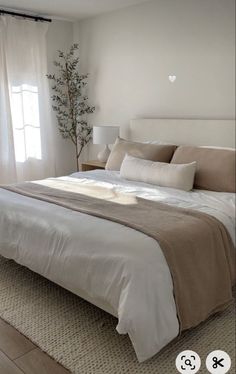 a bedroom with a large bed and white walls