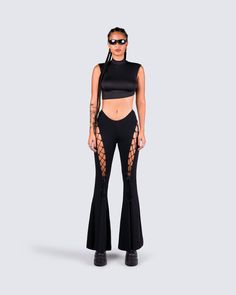 An all-black fit always exudes a "don't mess with me" kind of vibe 😈 Intimidate and entice them all with this 2 piece set, featuring a black turtleneck crop top, paired with black lace-up flared pants 🖤 Edgy High Stretch Crop Top For Night Out, Edgy High-stretch Crop Top For Night Out, Gothic Crop Top For Night Out, Gothic Cropped Top For Night Out, Gothic Stretch Crop Top, Gothic Stretch Cropped Crop Top, Edgy Cropped Stretch Bottoms, Black Cropped Bottoms For Streetwear, Black Cropped Streetwear Bottoms