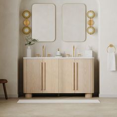 a bathroom with two sinks and mirrors on the wall