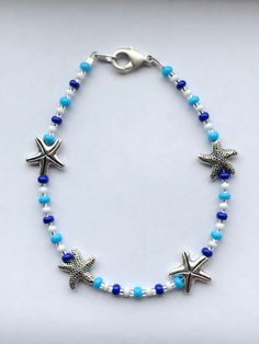 Anklet beaded with blue glass seed beads and silver plated starfish beads finished with a stainless steel clasp. Beachy Jewlery, Anklets To Make, Diy Anklets, Seed Bead Anklet, Anklets Diy, Starfish Anklets, Ankle Bracelets Diy, Bead Anklet, Handmade Anklets