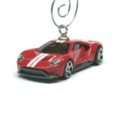 a red sports car keychain with a white stripe on it's side