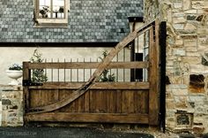 an image of a wooden gate in front of a house