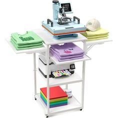 a sewing machine sitting on top of a table with several different colored fabrics and papers