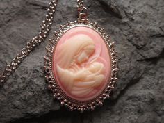 "Wonderful look for Easter and Christmas!! Beautiful Virgin Mary cradling baby Jesus cameo necklaces. The cameos are gorgeous. I do have many other colors, finishes and styles, so please do browse, I can make any larger cameo in my shop into this pretty necklace, so browse and message me with a custom order The pretty setting is classically beautiful rose gold tone, which measures about 2 1/4\" long. The chain is a matching 24\" rose gold link chain with a lobster claw clasp, if you would prefer Personalized Pink Jewelry For Christmas, Vintage Necklace For Christmas Gift, Vintage Necklaces For Christmas Gifts, Handmade Pink Jewelry For Holiday, Vintage Christmas Gift Necklaces, Vintage Pink Necklace For Mother's Day, Handmade Pink Jewelry For Christmas, Handmade Pink Necklace For Mom, Elegant Pink Christmas Jewelry