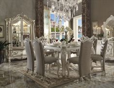 a dining room table with chairs and a chandelier