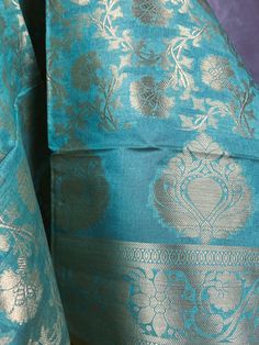 Stunning Banarasi Dupatta in Pastel Sea BlueColor with Muted Zari Weaving. Floral Design in Jaal with tassles. Give your Outfit a new look with these beauties. ❤️ Item: Dupatta Base color : Pastel Sea Blue Fabric : Soft Semi Silk (Not Pure Silk) Work : Zari Weaved with tassels Length of the Dupatta : 92 inches approx. Width of the dupatta : 35 inches (Approx.) Store Policies - No return or exchange will be accepted for color variations. - No return or exchange will be accepted if the color does not match your other clothing or your partners or anyone else. - Since this Dupatta is handmade hence little inconsistencies may be there however it is not considered as a defect. - Zari or thread coming out or on folds is not considered as defects. - Slight variation in actual color vs. image is po Blue Raw Silk Dupatta For Puja, Blue Jamawar Handloom Traditional Wear, Blue Jamawar Dupatta For Puja, Blue Tussar Silk Dupatta With Motifs, Blue Tussar Silk Dupatta With Self Design, Blue Jamawar Dupatta With Self Design, Blue Handloom Dupatta For Wedding, Blue Handloom Lehenga For Traditional Ceremonies, Handloom Lehenga For Celebration