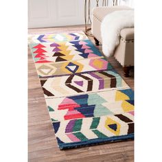 a multicolored rug on the floor in a living room