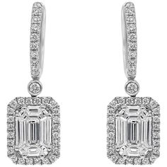 An elegant pair of dangle earrings, showcasing mixed-cut diamonds, invisibly set in an illusion design. Surrounded by a halo of round brilliant cut diamonds and suspended on a diamond encrusted hoop. Diamonds weigh 1.22 carats total. Finely made in 18K white gold.  Roman Malakov is a custom house, specializing in creating anything you can imagine. If you would like to receive a special quote on a custom piece, please message or call us. Gia Certified Diamond Drop Earrings, Diamond White Baguette Cut Halo Earrings, Diamond White Baguette Cut Earrings With Halo Design, Diamond Emerald-cut Halo Earrings, Emerald Cut Diamond Earrings, Illusion Design, Halo Diamond Earrings, Cut Earrings, Solitaire Earrings